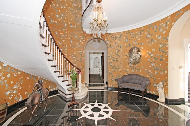 2 Wallis Ln, Nissequogue, NY 11780 - entryway featuring arched walkways, wallpapered walls, stairs, a chandelier, and baseboards