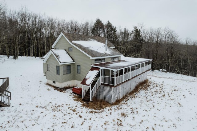 26 Beckys Hill Rd, Hurleyville, NY 12747 - snow covered rear of property featuring stairs, a deck, and a sunroom
