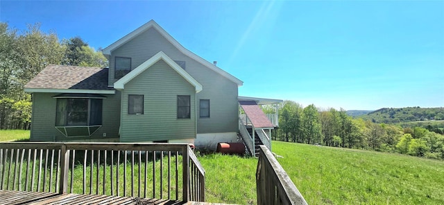 26 Beckys Hill Rd, Hurleyville, NY 12747 - view of property exterior with a lawn, a shingled roof, and a wooded view