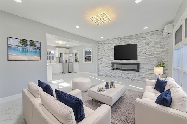 52 State St, Valley Stream, NY 11580 - living area featuring light marble finish floors, a wall mounted air conditioner, recessed lighting, a large fireplace, and baseboards