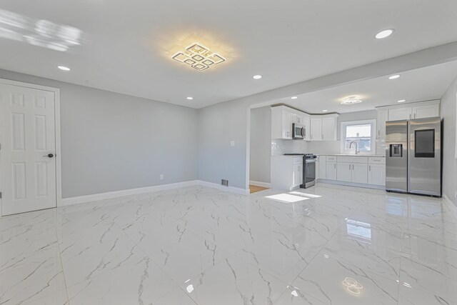 52 State St, Valley Stream, NY 11580 - unfurnished living room featuring baseboards, a sink, recessed lighting, and light marble finish flooring