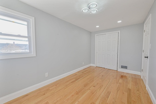 52 State St, Valley Stream, NY 11580 - unfurnished bedroom featuring baseboards, light wood-type flooring, a closet, and recessed lighting
