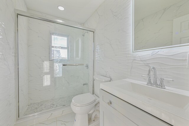 52 State St, Valley Stream, NY 11580 - bathroom with tile walls, marble finish flooring, a marble finish shower, toilet, and vanity