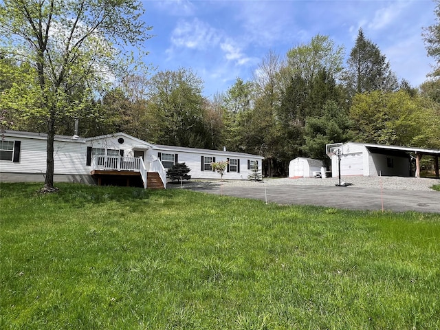 265 Old Tacy Rd Unit Tr95, Swan Lake, NY 12783 - view of front of house featuring a wooden deck, a carport, a front yard, and an outdoor structure