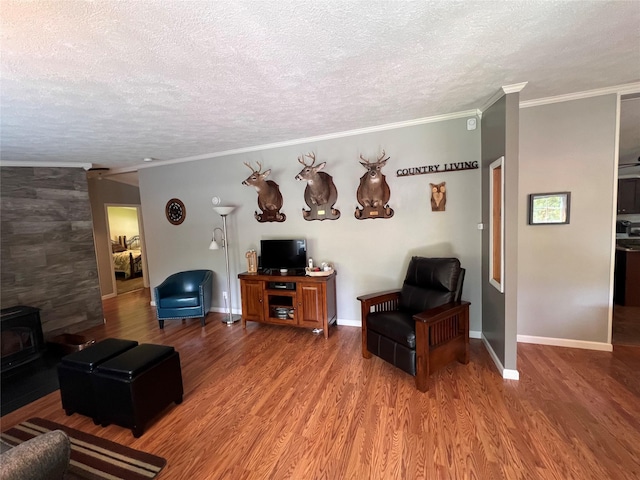 265 Old Tacy Rd Unit Tr95, Swan Lake, NY 12783 - living room with a wood stove, a textured ceiling, wood finished floors, crown molding, and baseboards
