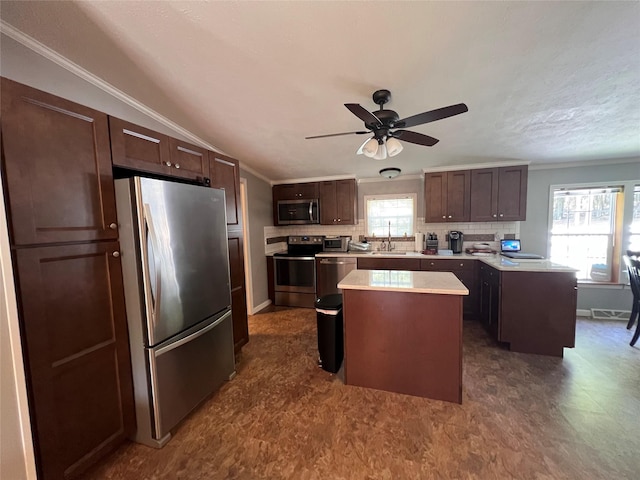 265 Old Tacy Rd Unit Tr95, Swan Lake, NY 12783 - kitchen featuring stainless steel appliances, a center island, light countertops, healthy amount of natural light, and ornamental molding