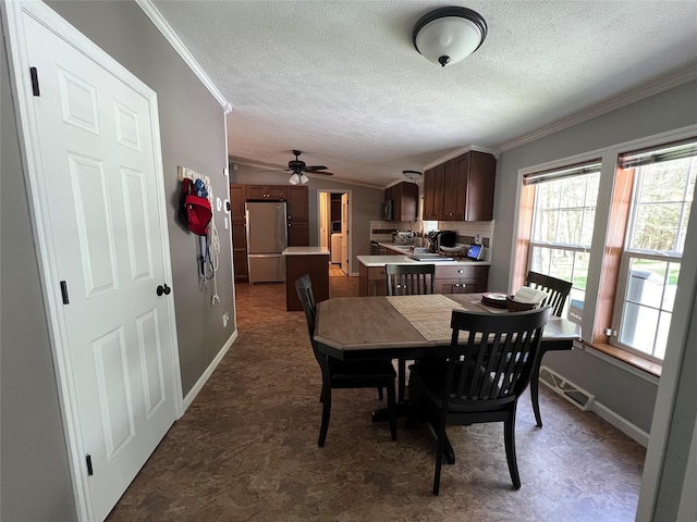 265 Old Tacy Rd Unit Tr95, Swan Lake, NY 12783 - dining room featuring ornamental molding, a textured ceiling, baseboards, and a ceiling fan
