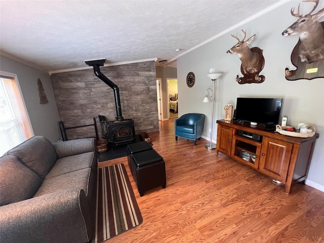 265 Old Tacy Rd Unit Tr95, Swan Lake, NY 12783 - living room featuring a wood stove, light wood finished floors, a textured ceiling, ornamental molding, and baseboards