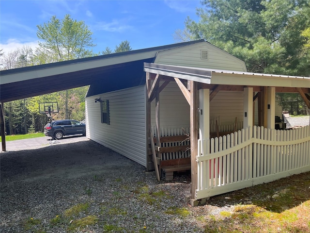 265 Old Tacy Rd Unit Tr95, Swan Lake, NY 12783 - view of side of home with an attached carport, driveway, and fence