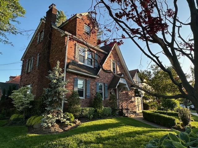 163-18 Cryders Ln, Whitestone, NY 11357 - view of side of property featuring a yard, a chimney, and brick siding