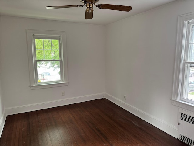 163-18 Cryders Ln, Whitestone, NY 11357 - empty room featuring radiator heating unit, dark wood finished floors, healthy amount of natural light, and ceiling fan