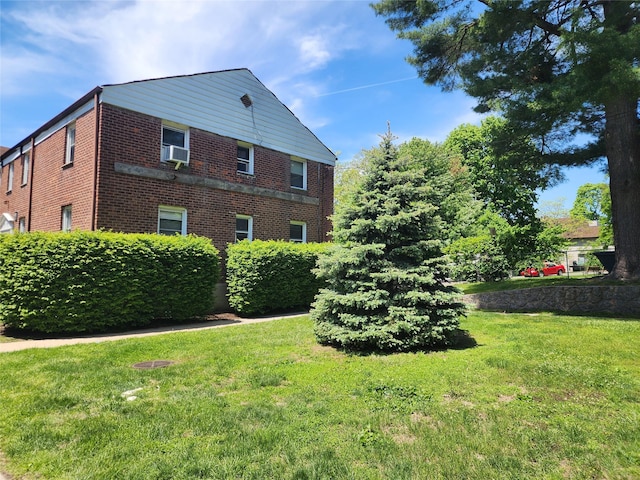 79 N Broadway Unit H, White Plains, NY 10603 - view of home's exterior featuring brick siding and a lawn