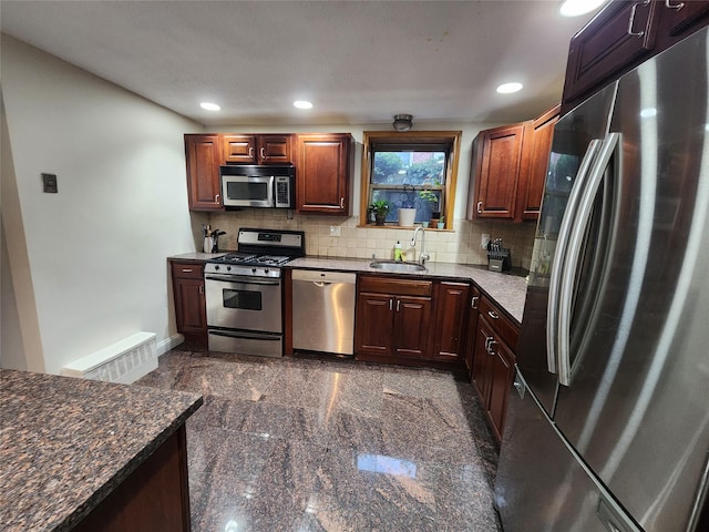 79 N Broadway Unit H, White Plains, NY 10603 - kitchen featuring appliances with stainless steel finishes, a sink, granite tiled floors, backsplash, and recessed lighting