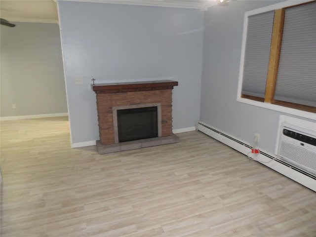 unfurnished living room featuring a baseboard heating unit, ornamental molding, wood finished floors, a stone fireplace, and baseboards