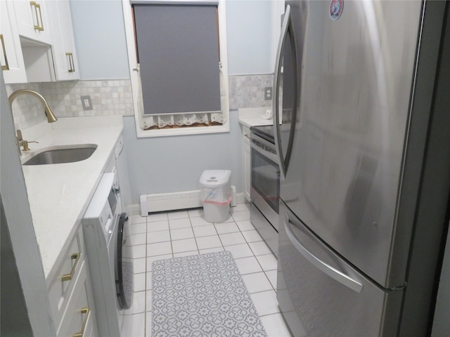 bathroom featuring a baseboard heating unit, tile patterned floors, decorative backsplash, and vanity