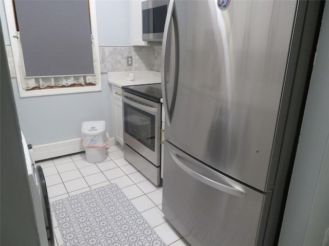 kitchen with stainless steel appliances, a baseboard radiator, white cabinets, light countertops, and light tile patterned floors
