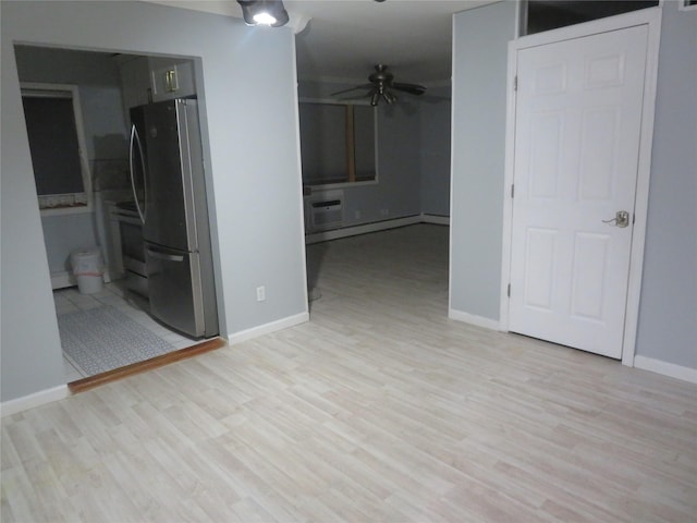 empty room featuring light wood-style flooring, ceiling fan, and baseboards