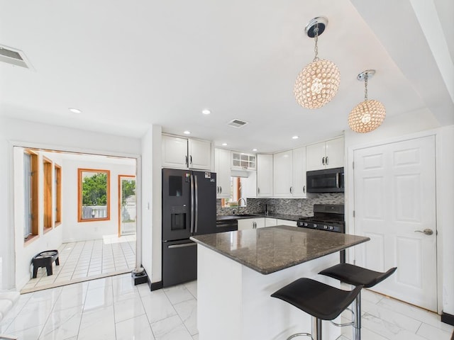 kitchen with black appliances, light marble finish floors, a sink, white cabinets, and recessed lighting