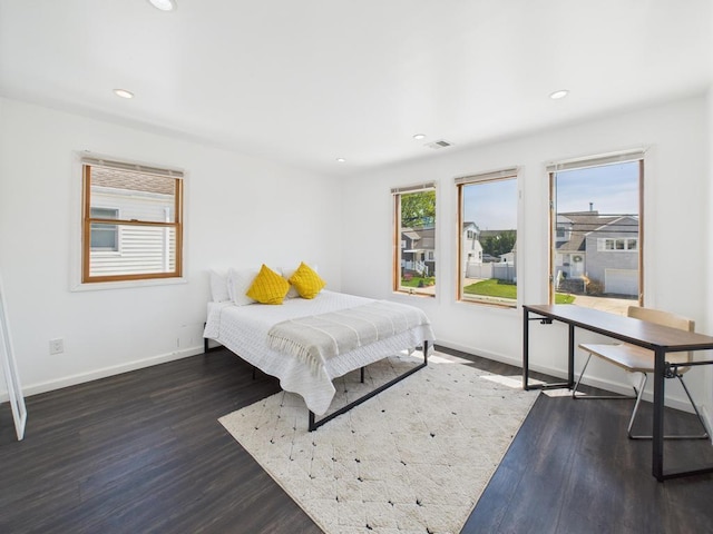 bedroom with wood finished floors, baseboards, and recessed lighting
