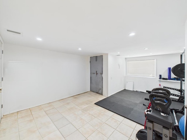 exercise room with recessed lighting and light tile patterned floors