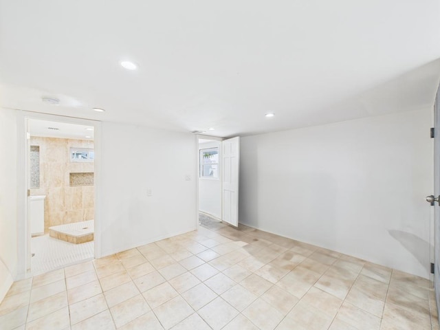 spare room with recessed lighting, light tile patterned flooring, and a smoke detector