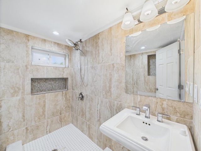 full bath with tiled shower and a sink