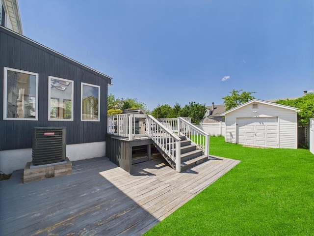 wooden deck featuring central AC, a yard, an outbuilding, a detached garage, and stairs