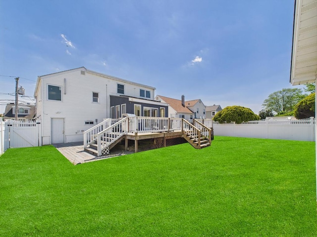 rear view of property featuring stairway, a deck, and a gate