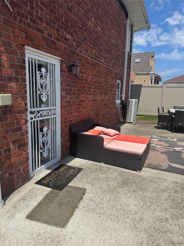 163-33 90th St, Howard Beach, NY 11414 - doorway to property featuring central AC unit, brick siding, and a patio