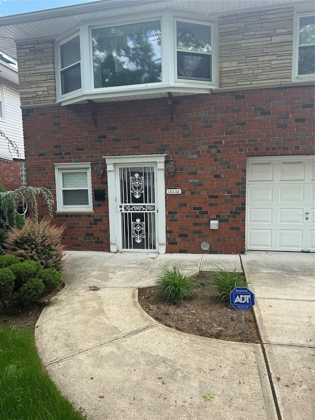 163-33 90th St, Howard Beach, NY 11414 - property entrance with brick siding and an attached garage