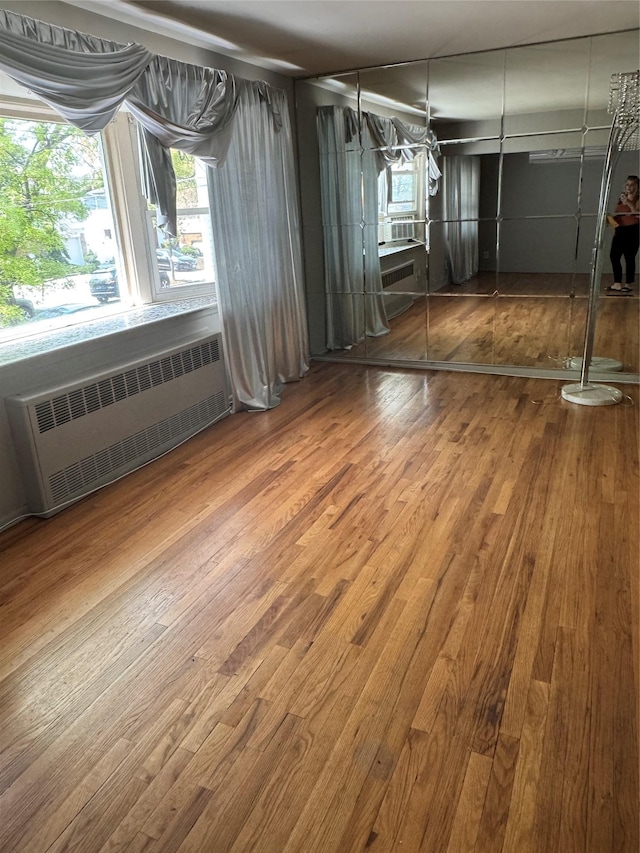 163-33 90th St, Howard Beach, NY 11414 - unfurnished dining area with radiator heating unit and wood finished floors