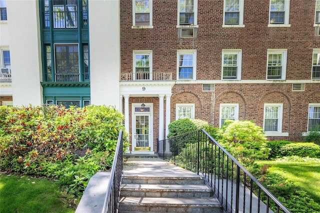 view of exterior entry featuring brick siding