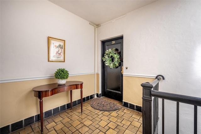 entryway with brick patterned flooring