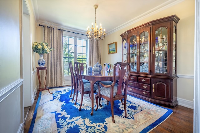 dining area with a chandelier, crown molding, wood finished floors, and baseboards