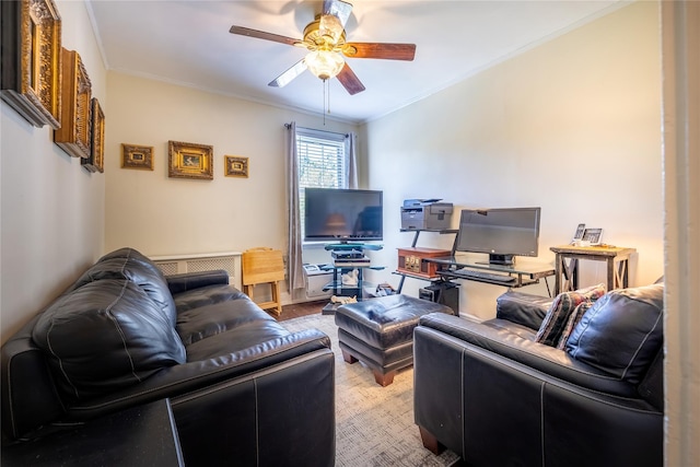 living room with ceiling fan, crown molding, and wood finished floors