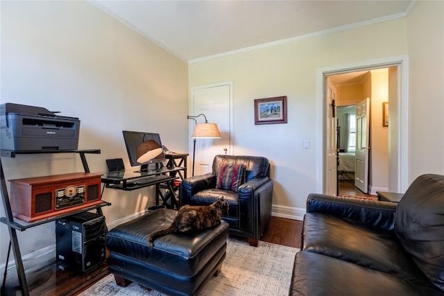 living area featuring ornamental molding, wood finished floors, and baseboards