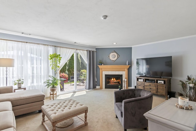 living room featuring ornamental molding, a tile fireplace, and light carpet