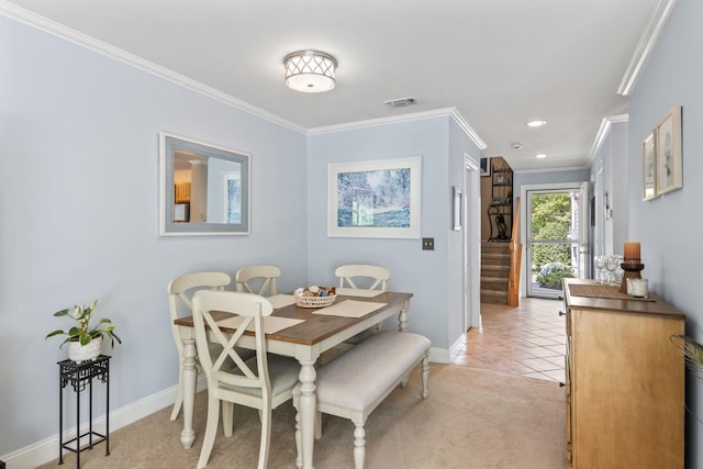 dining room featuring baseboards, ornamental molding, stairs, light tile patterned floors, and light carpet