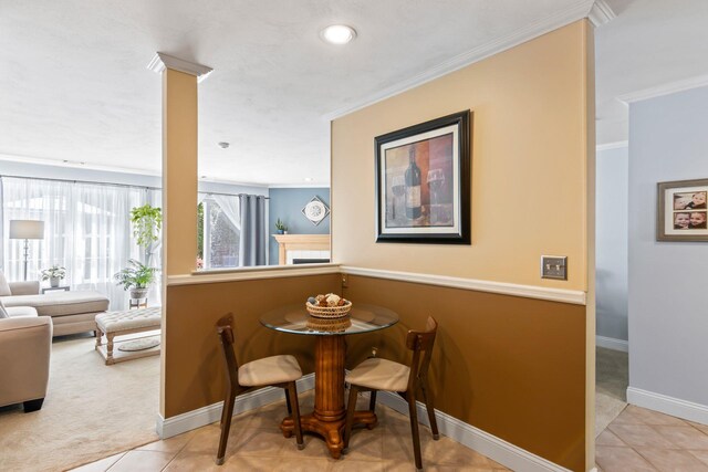 tiled dining space with ornamental molding, carpet, baseboards, and recessed lighting