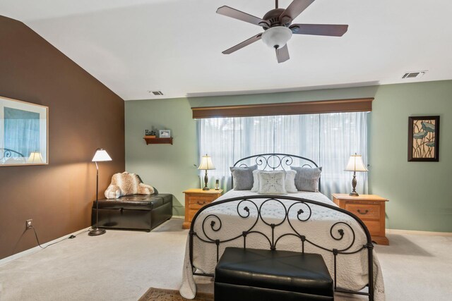 carpeted bedroom with baseboards, vaulted ceiling, and ceiling fan