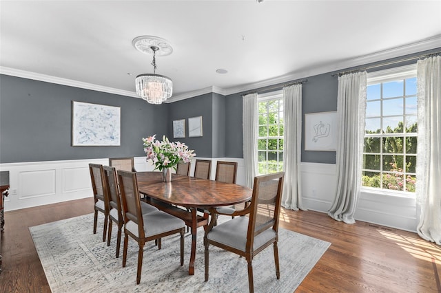 2 Cerf Ln, Mount Kisco, NY 10549 - dining room featuring a chandelier, a wainscoted wall, crown molding, wood finished floors, and a decorative wall