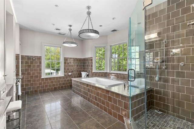 2 Cerf Ln, Mount Kisco, NY 10549 - full bathroom with tile walls, tile patterned floors, a stall shower, a garden tub, and wainscoting