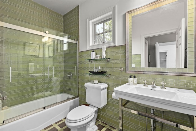 2 Cerf Ln, Mount Kisco, NY 10549 - bathroom with tile walls, toilet, bath / shower combo with glass door, and tasteful backsplash