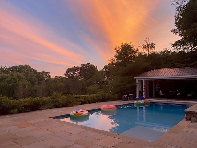 2 Cerf Ln, Mount Kisco, NY 10549 - pool at dusk featuring an outdoor pool and a patio