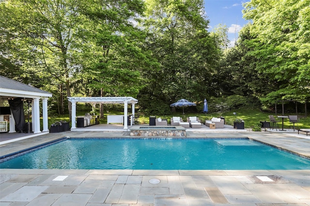 2 Cerf Ln, Mount Kisco, NY 10549 - swimming pool with a pergola, a patio area, an outdoor hangout area, and view of wooded area