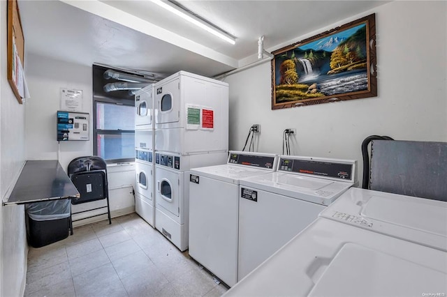 communal laundry room with estacked washer and dryer, separate washer and dryer, and light tile patterned flooring