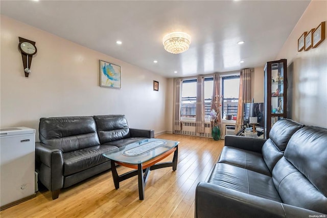 living area with light wood finished floors, recessed lighting, and baseboards