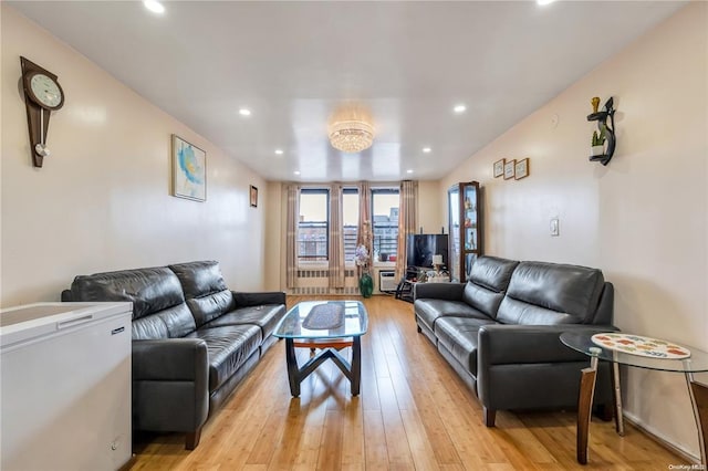living area with light wood-style floors and recessed lighting