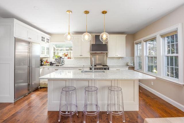 7203 Ingram St, Forest Hills, NY 11375 - kitchen featuring built in refrigerator, wall chimney range hood, a sink, dark wood-style floors, and backsplash