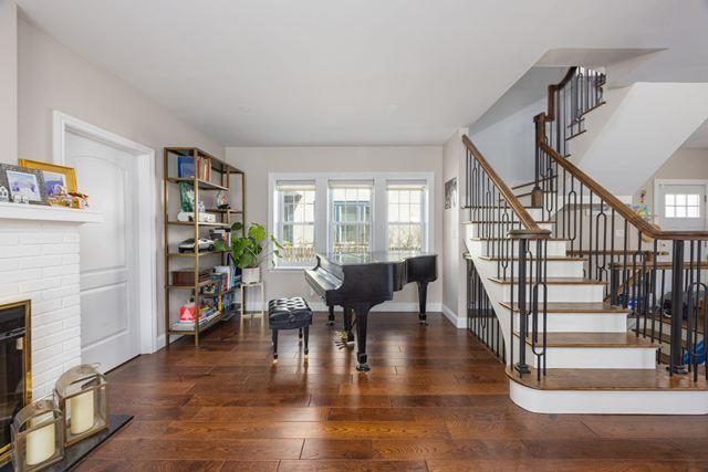 7203 Ingram St, Forest Hills, NY 11375 - entrance foyer featuring wood-type flooring, stairway, and a fireplace